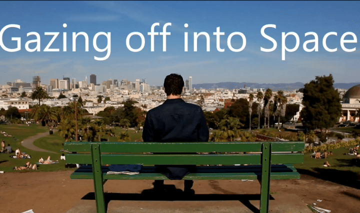 man sitting on bench, skyline, city view, contemplating man