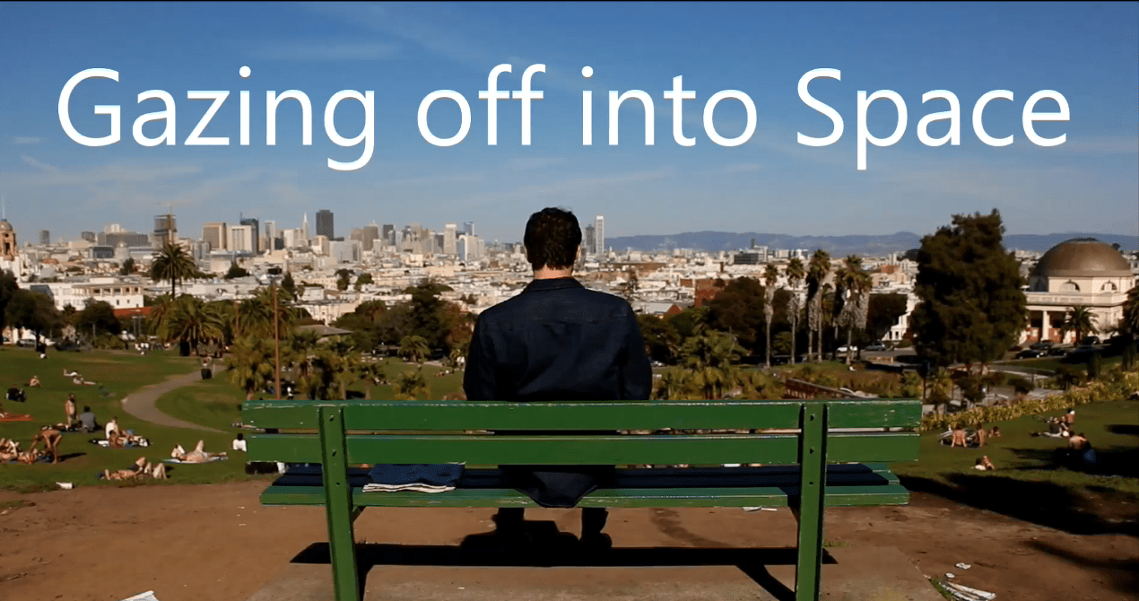 man sitting on bench, skyline, city view, contemplating man